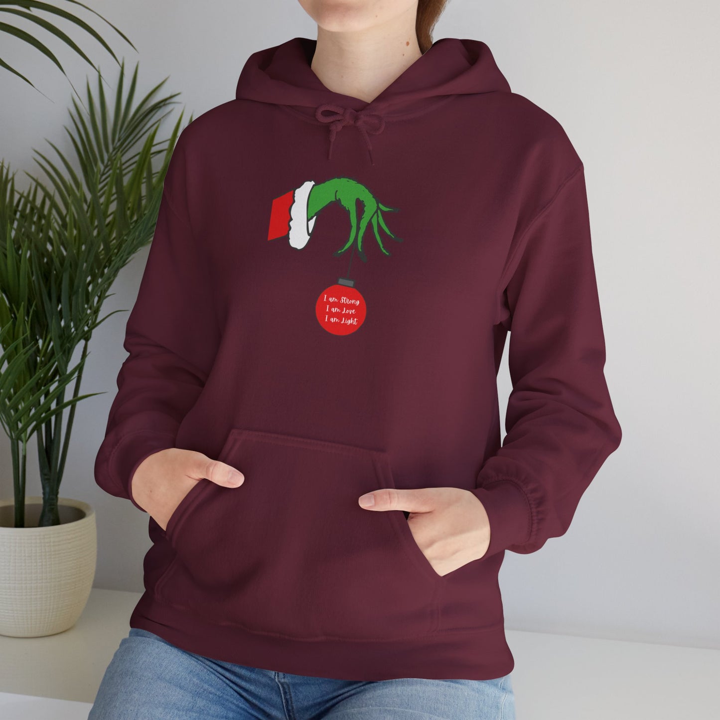 Grinch Hand Holding Ornament Hoodie